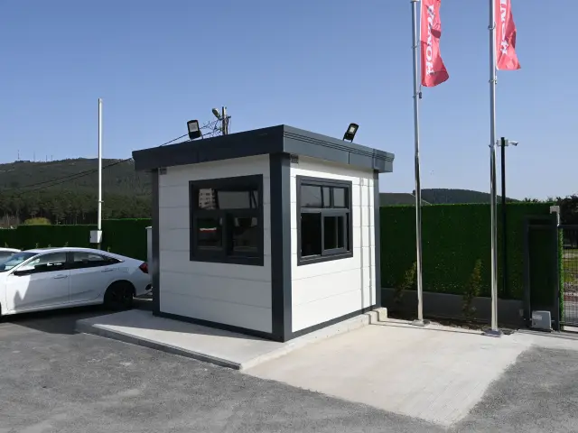 MetroCity gatehouse at a car showroom vehicle entrance, with floodlights on its roof